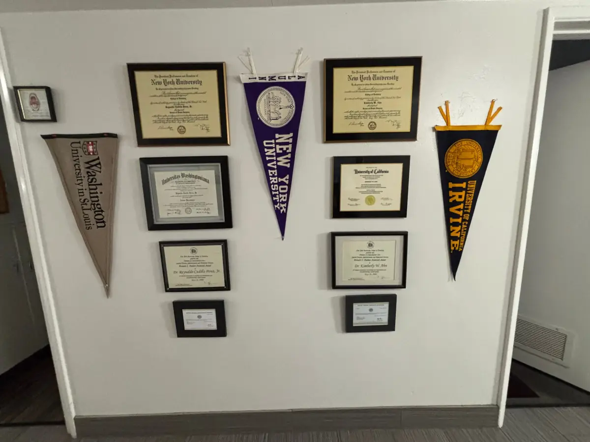 Dr. Perez's and Dr. Ahn's diplomas from the New York University College of Dentistry on the office wall