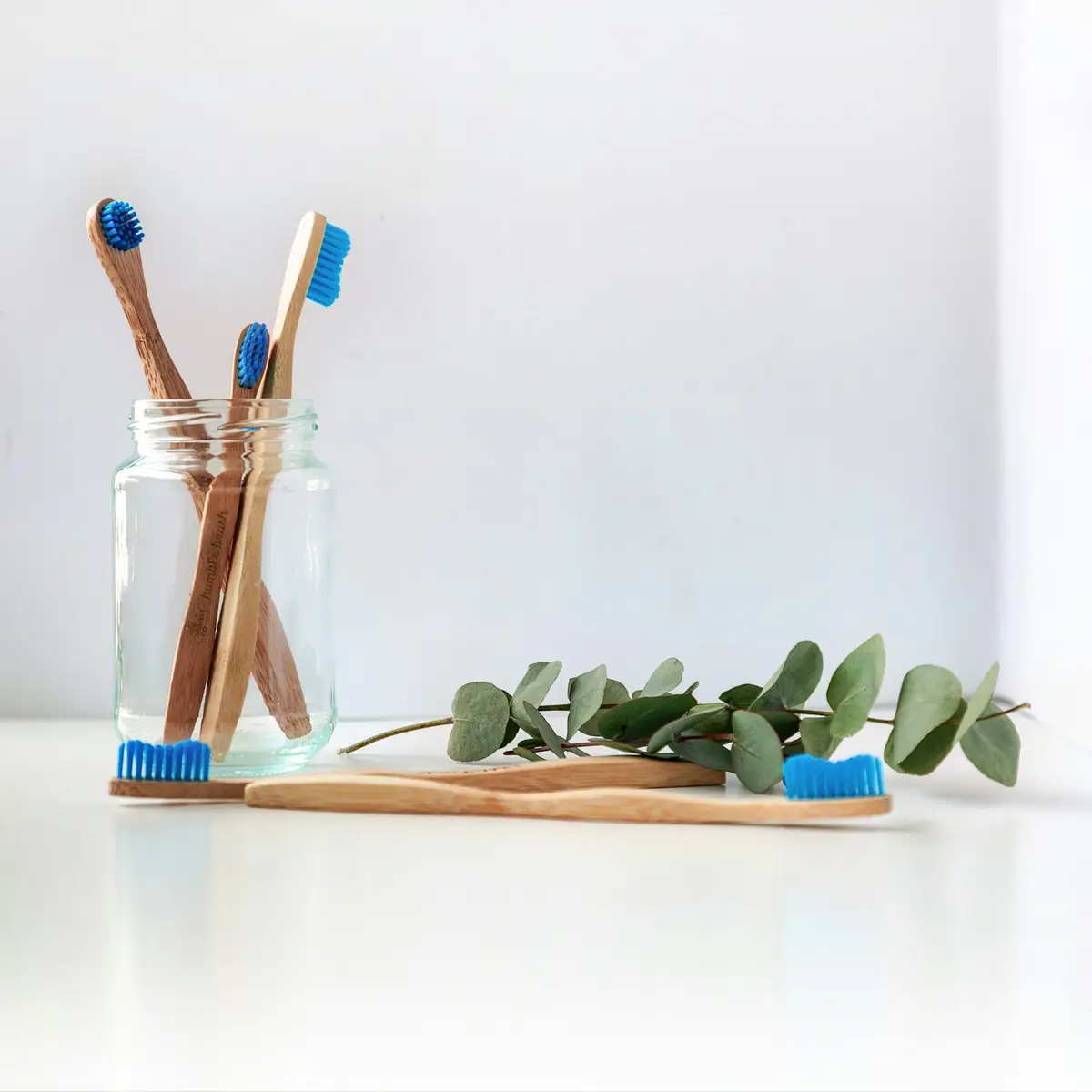 Toothbrushes in a glass jar
